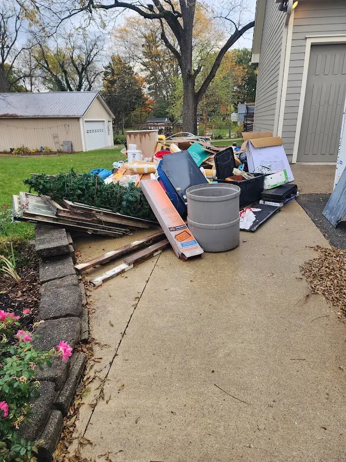 Dumpster being loaded with debris for 10 Yard Dumpster Rental in Sedona